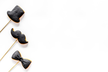 Happy fathers day morning with black tie, mustache and hat cookies for celebrate white background top view mock upの写真素材