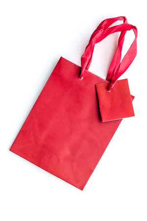 Red bright shopping bag on white background top view mockupの写真素材