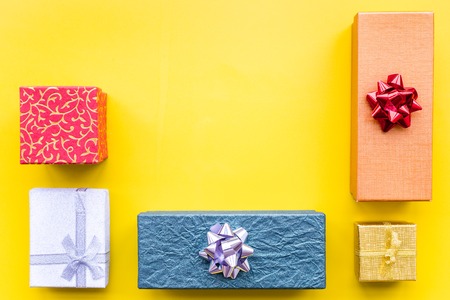 Wrapped gifts for boxing day 2018 pattern on yellow background top view copyspace