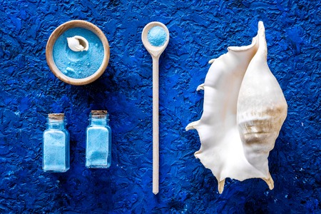 spa set with blue sea cosmetics for bath and shell on blue desk background top viewの写真素材