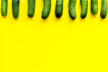 Fresh cucumbers pattern on yellow background top view.の写真素材