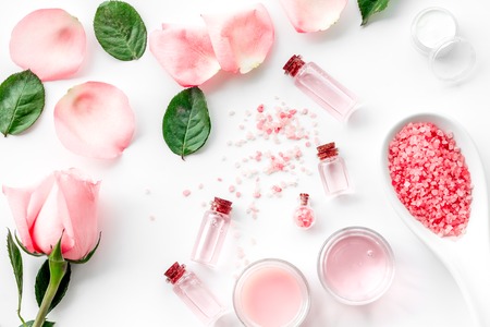 Natural organic cosmetics with rose oil. Cream, lotion, spa salt on white background top viewの写真素材