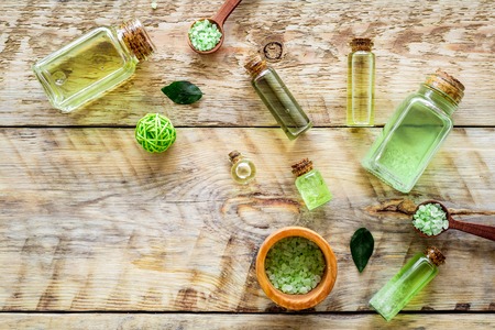 Skin care products with tea tree oil in bottles on rustic wooden top view pattern copyspaceの写真素材