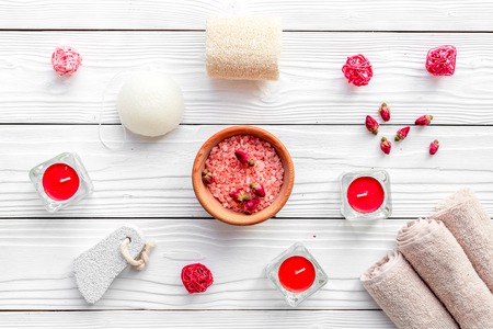 Romantic set for foot spa. Candles, salt, pumice stone, soap on white wooden background top view.の写真素材