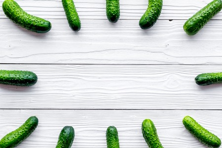 Pattern with fresh cucumbers. Grey wooden background top view.の写真素材
