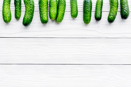 Pattern with fresh cucumbers. Grey wooden background top view.の写真素材