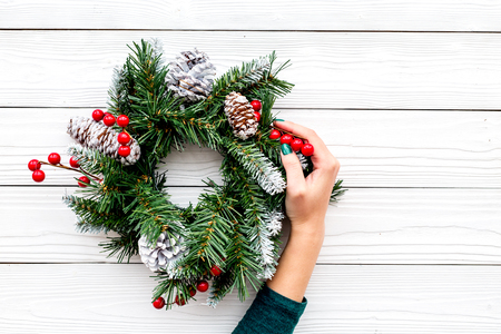 Decorate the house for winter holidays. Christmas wreath on white wooden background top view copyspaceの写真素材