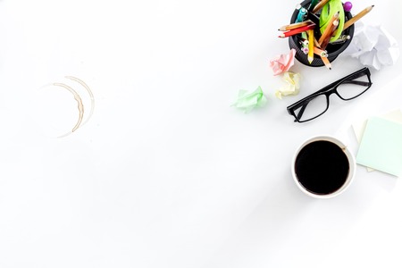 Deadline in office. Desk with crumpled paper and coffee stains. White background top view copyspaceの写真素材
