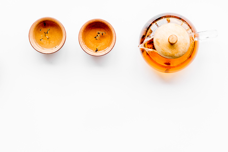 Tea ceremony concept. Tea pot, cups or bowls on white background top view copyspaceの写真素材