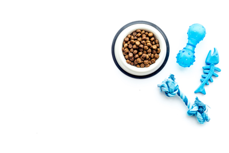 Concept pet care, playing and training. Toys, accessories and feed on white background top view copyspaceの写真素材