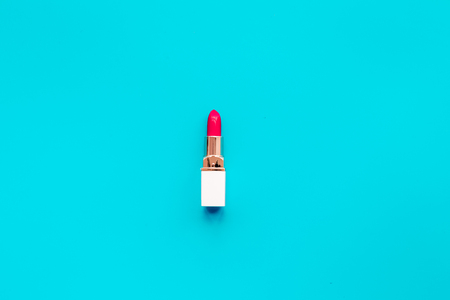 Red lipstick on blue background top view copyspaceの写真素材