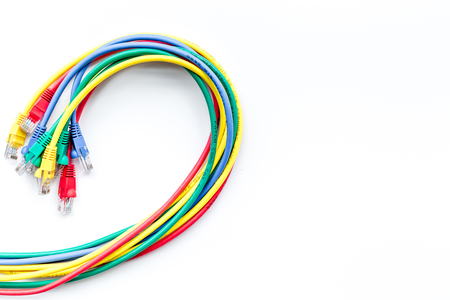 Colored patch-cord on white background top view copyspace