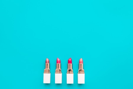 Lipsticks assorted colors on blue background top view.の写真素材