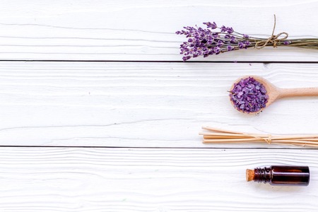 Aromatherapy for relax concept. Lavender branch, spa salt and oil on white wooden background top view copyspaceの写真素材