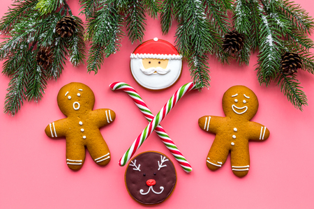 Gingerbread man cookies for New Year meal near spruce branch on white background top viewの写真素材