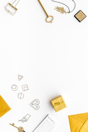 Office desk in trendy gold color. Glittering stationery on white background top view.の写真素材