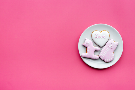 Valentine cookies. Hearts with lettering I love you, cat and puppy on pink background top view.の写真素材