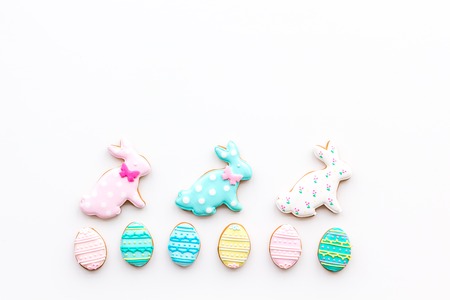 Easter background. Cookies in shape of easter bunny and easter eggs. White background top view space for textの写真素材