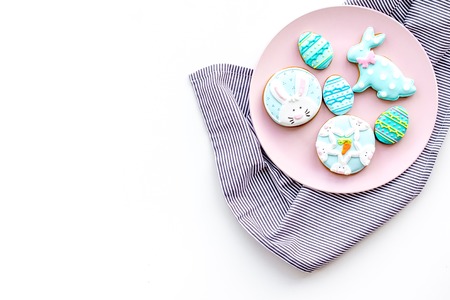 Easter background. Cookies in shape of easter bunny and easter eggs. White background top view space for textの写真素材