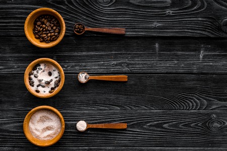 Cosmetics for skin care and relaxation. Chocolate brown spa salt on dark wooden background top view copy spaceの写真素材