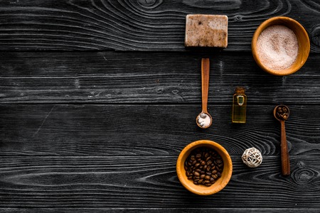 Cosmetics for skin care and relaxation. Chocolate brown spa salt on dark wooden background top view copy spaceの写真素材