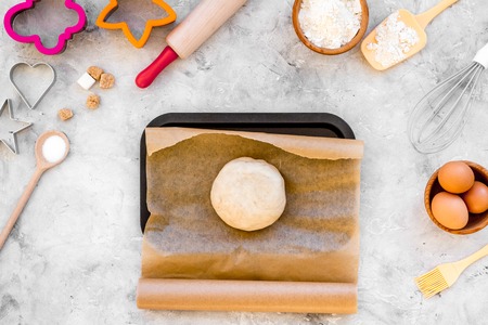 Make dough. Ingedients flour, eggs near cookware on grey background top view.の写真素材