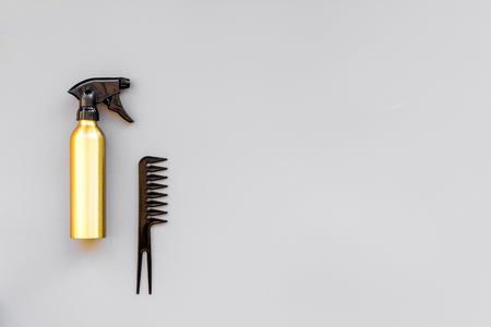 Professional hairdressing tools in beauty saloon. Combs, spray on grey background top view copy spaceの写真素材
