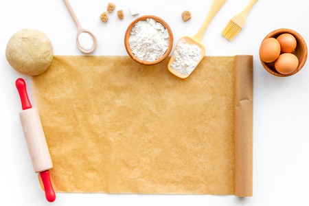 Prepare to baking. Dough ball near cookware on white background top view. Mock up with baking paperの写真素材