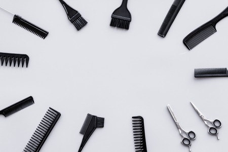 Beauty saloon equipment. Hairdress and haircut. Combs, sciccors, brushes on grey background top view.の写真素材