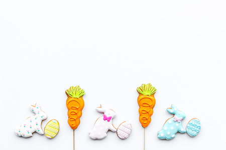 Sweets, pastry for Easter table. Easter eggs and Easter bunny concept. White background top view space for textの写真素材