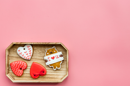 Sweets on Valentine's Day. Cookies in shape of heart and with lettering I love you on pink background top view.の写真素材