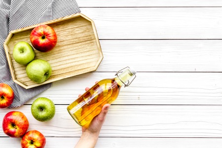 Homemade cider from ripe apples. White wooden background top view copy spaceの写真素材