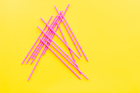 Drinking straws on yelllow pastel background top view.の写真素材