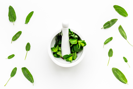 Herbal medicine. Healing herbs in mortar bowl on white background top view copy space patternの写真素材