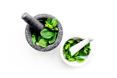 Herbal medicine. Herbs in mortar bowl on white background top view.の写真素材
