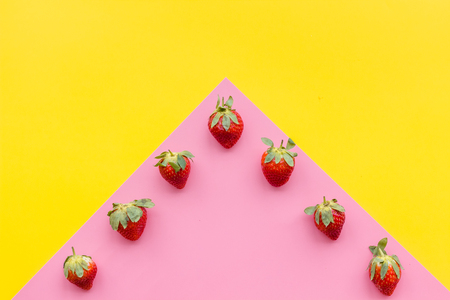 Fresh ripe strawberry. Pattern on yellow pastel background top view.の写真素材