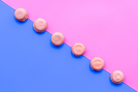 Macarons dessert. Pattern on blue and pink pastel background top view.の写真素材