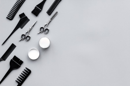 Beauty saloon equipment. Hairdress and haircut. Combs, sciccors, brushes on grey background top view.の写真素材