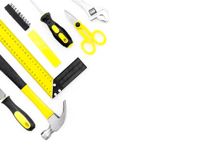 Repair tool kit. File, hummer, corner ruler on white background top view.