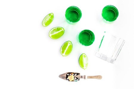Make cocktail with absinthe. Shaker, shots, lime slices on white background top view,の写真素材