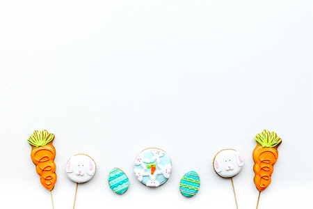 Sweets, pastry for Easter table. Easter eggs and Easter bunny concept. White background top view...