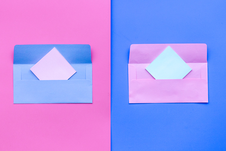 Color envelope on pink and blue pastel background top view copy space pattern