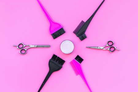 Professional hairdressing tools in beauty saloon. Sciccors, brushes on pink background top viewの写真素材