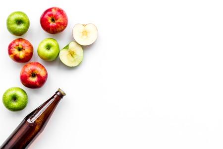 Apple cider. Low-alcoholic beveradge in dark bottle on white background top view.