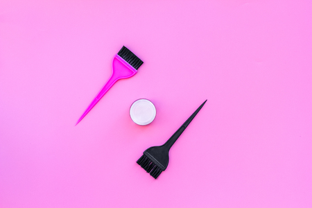 Dye hair in beauty salon. Set of brushes on pink background top view.の写真素材