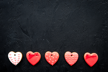 St Valentine's Day cookies in shape of heart on black background top view.の写真素材