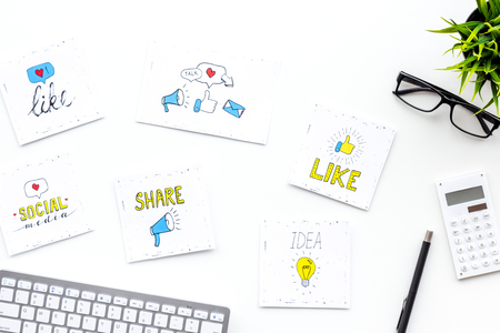 Digital marketing. Work desk of marketing specialist with social media icons and symbols on white background top view.の写真素材