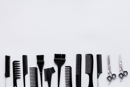 Hairdressing tools. Pattern with various combs and brushes on grey background top view.の写真素材