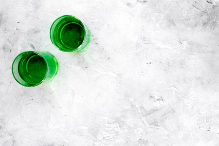 Absinthe shots on grey stone background top view.の写真素材