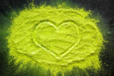 Mockup with matcha powder tea on black background top view.
